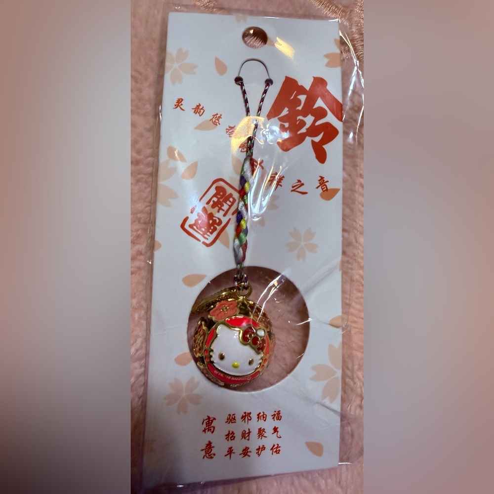 New Hello Kitty Gold Round Bell Charm features delightful sakura design 💖